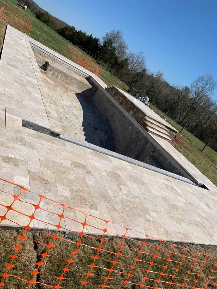 Close view of stone pool paving beside a swimming pool