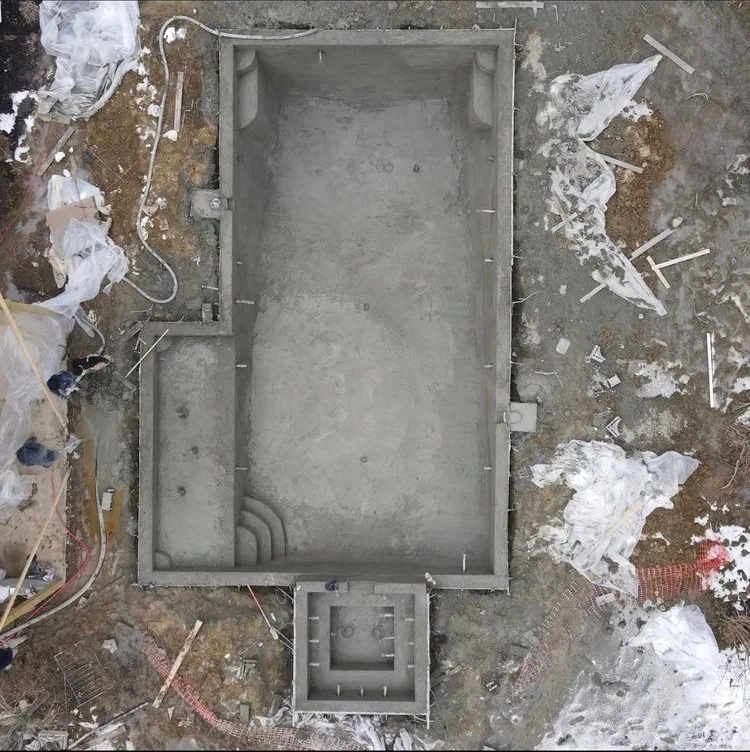 Overhead view of a concrete swimming pool shell during construction
