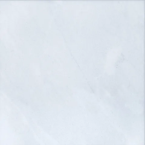 Stonelux Afyon White Marble sample with a white background and subtle grey markings