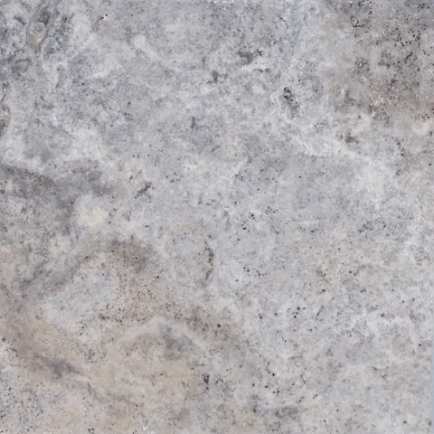 Stonelux Silver Travertine sample with silver-grey and warm natural markings